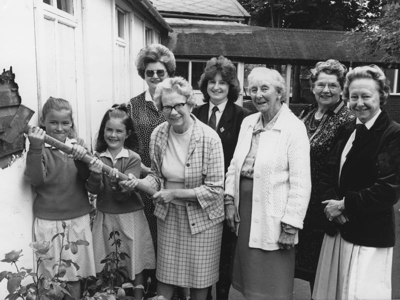 Mrs Audie Stafford delivers the blow which initiated the demolition of the wooden classrooms at Elmslie Girls School on Whitegate Drive