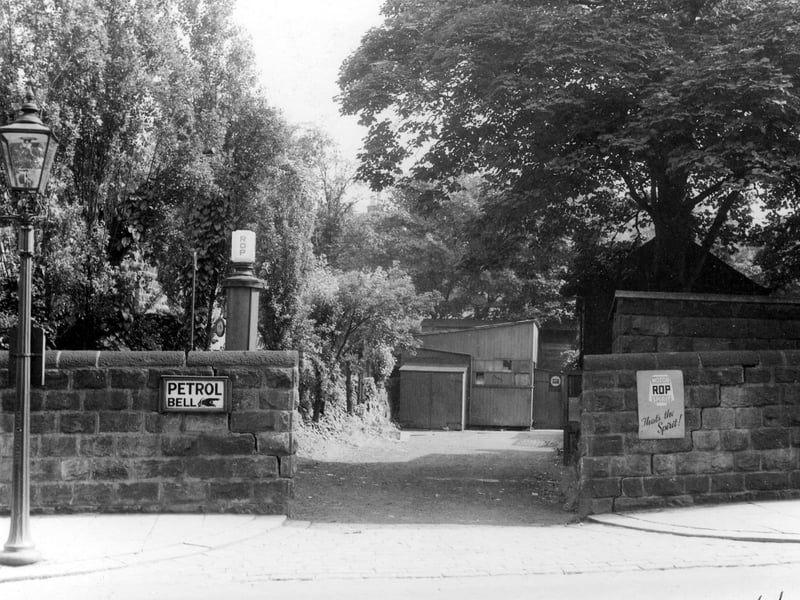 Petrol pumps on Shaw Lane, probably at junction with Otley road, with petrol pumps, gas lamps to left of picture, a sign saying "petrol bell", outhouses and an advert for ROP motor spirit. Pictured in August 1939.