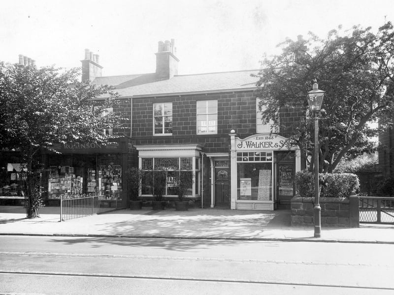 J Walker and Son, decorator's shop at no 46 Otley Road showing wallpaper in the window. Also shown is number 48, A Robinson, Stationers. Pictured in July 1935.