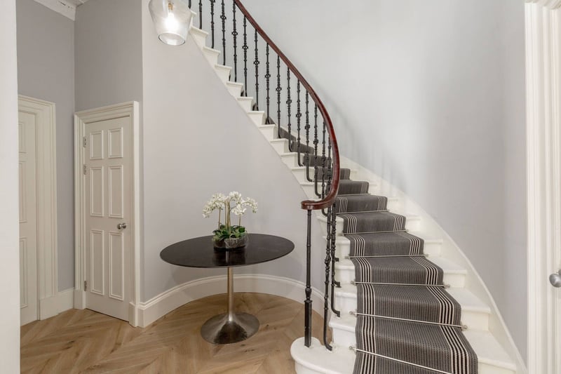 The twisting staircase, as well as leading to the upper floor rooms, provides a stunning focal point within the flat.
