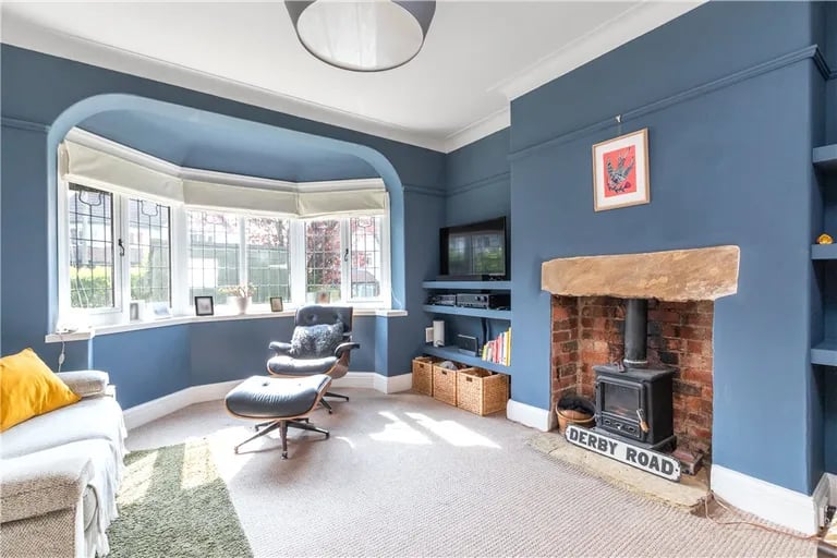 The stunning lounge features a log burner and large bay window.