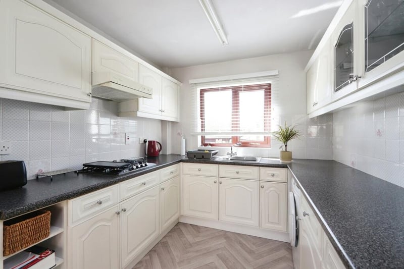 The kitchen has a simple and clean design, with all the utilities new owners could need.