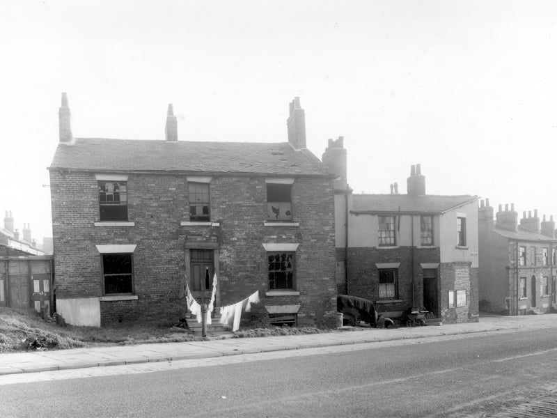 Derelict property on Dolly Lane in the Newtown locality in October 1958.. This area was scheduled for demolition at the time this photograph was taken and is now part of the Lincoln Green estate. The main house in the photograph is unnumbered on the City Engineers map but to the right is number 28 Dolly Lane and a pram is parked outside . It may be the occupants of this house who have taken the opportunity to hang out the family washing in front of the derelict house.