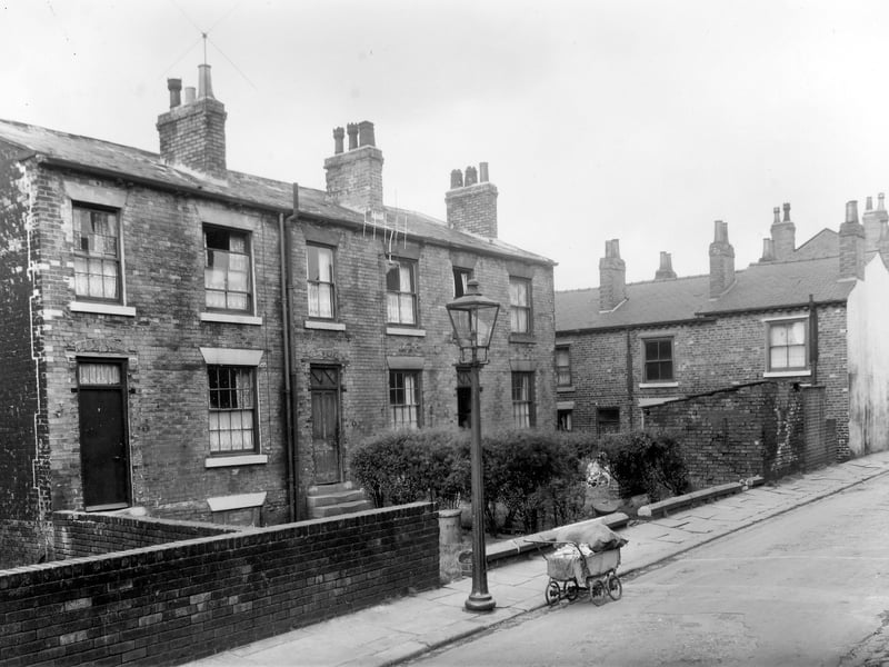 Three brick built terraced houses on Haymount Street in an area of Newtown designated for clearance. An ancient pram almost buckles under the weight of bundles of chips obviously being sold around the streets for fire lighters. this area is now part of the Lincoln Green estate. Pictured in October 1958.