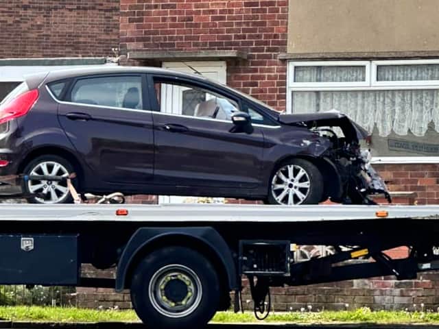 Ford Fiesta towed after crashing into property's brick wall in Woodhouse.