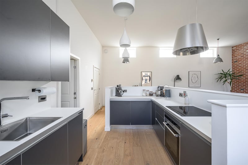 The modern kitchen is fitted with a range of units as well as a hob, oven and overhead extractor. It also has a slimline dishwasher, a fridge and a freezer.