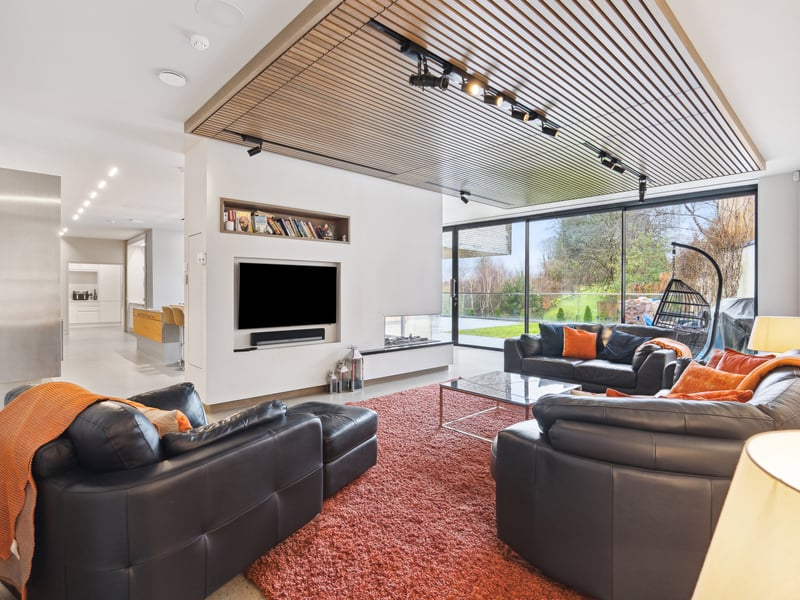 Interior: There is ample entertaining space with an open-plan kitchen, dining, and living space dominating, plus sauna and gym, and glazed doors opening to the outside. Meanwhile, the bedrooms are on the lower level, secluded by its gardens.