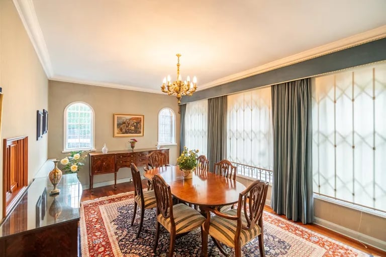 The dining room fits a large dining table where family and friends can gather.