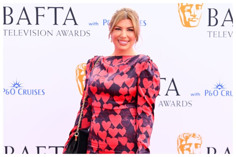 Unfortunately, Olivia Bowen's long sleeved heart motif dress just didn't work in the spring sunshine at the BAFTA 2024 Television Awards 
