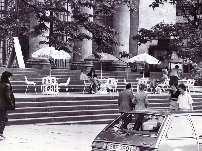 The scene in Barker's Pool in June 1985 is reminiscent of Paris, with colourful parasols over the tables, as shoppers enjoy a cuppa outside Sheffield City Hall