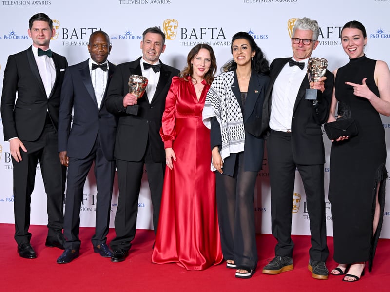 Tina Pawlik (fourth right) and Alisdair Flind (sixth right) along with the production crew, pose with the Drama Series Award for 'Top Boy' in the Winners Room during the 2024 BAFTA Television Awards.