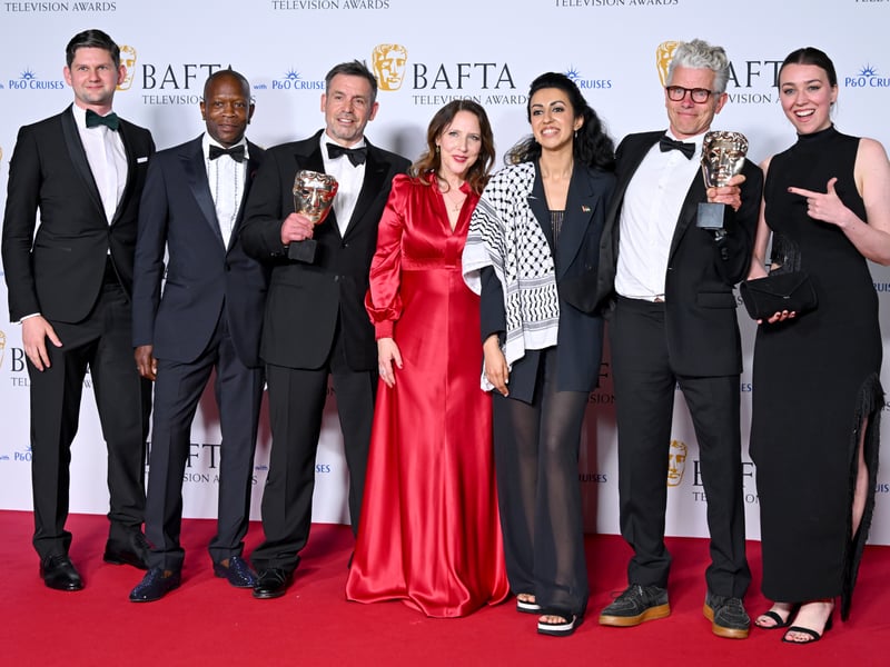 Tina Pawlik (fourth right) and Alisdair Flind (sixth right) along with the production crew, pose with the Drama Series Award for 'Top Boy' in the Winners Room during the 2024 BAFTA Television Awards.