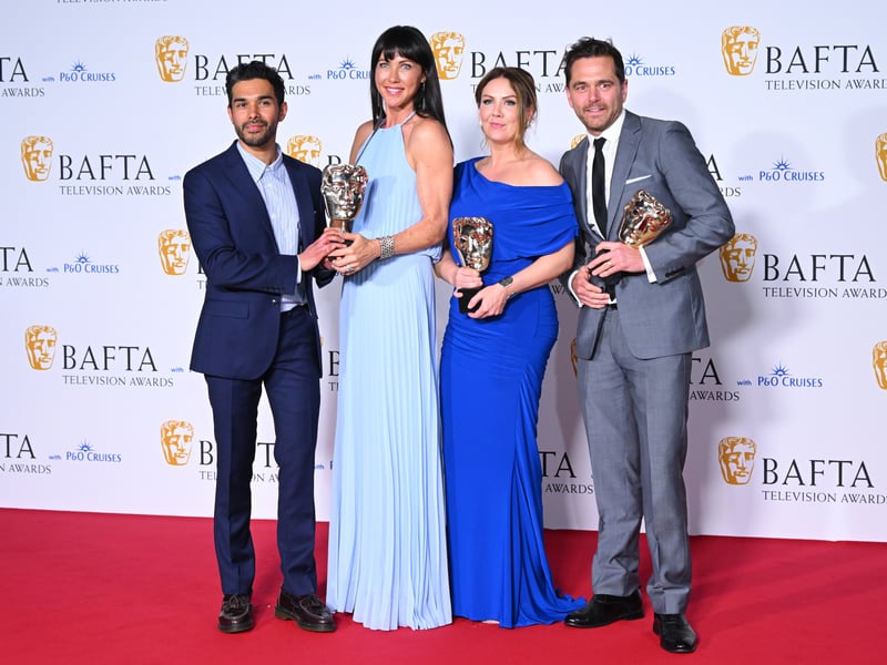 Neet Mohan, Kirsty Mitchell, Elinor Lawless and Michael Stevenson pose with the Soap Award for 'Casualty' in the Winners Room during the 2024 BAFTA Television Awards.