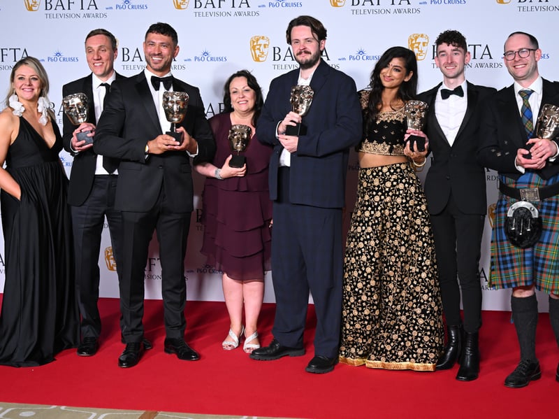 Odin Gillies, Rowland Stone, Rav Wilding, Sue Malone, Nick Stapleton, Harleen Nottay and Mark Lewis pose with the Daytime Award for 'Scam Interceptors' in the Winners Room during the 2024 BAFTA Television Award.