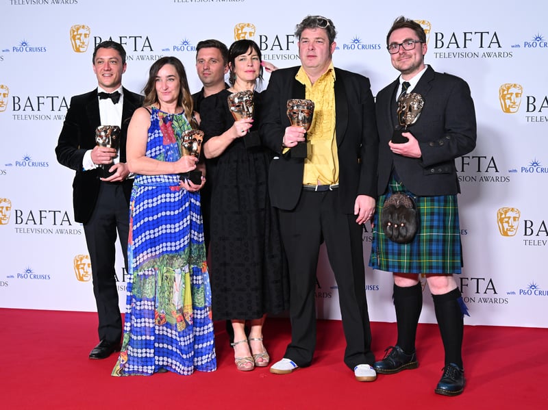 Dejan Cancar, Barnaby Fry, Claire McFall, Nancy Strang and John Dower pose with Factual Series Award in the Winners Room during the 2024 BAFTA Television Awards.