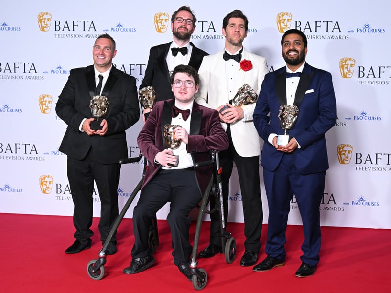 Jack Carroll (C) and production crew pose with the Short Form Award for 'Mobility' in the Winners Room during the 2024 BAFTA Television Awards.