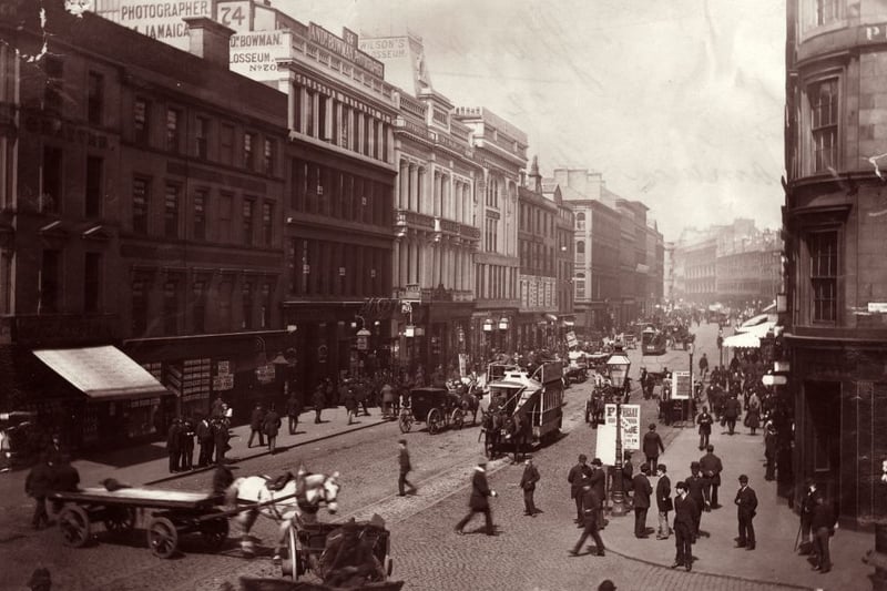 Circa 1895:  Passers-by and horse-drawn traffic in Jamaica Street.