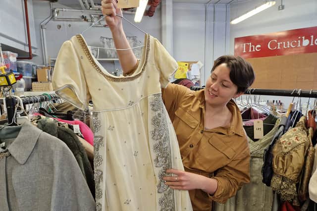 Caroline Bingley's dress out of Pride and Prejudice at the Crucible is one o the item's for sale, pictured here with wardrobe team member Kate Harrison. Photo: David Kessen, National World.
