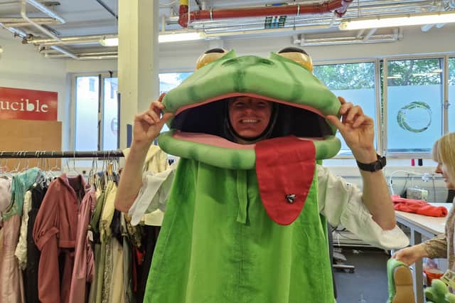 Reporter David Kessen tries on the frog costume from The Good Person of Szechwan. Photo: David Kessen, National World
