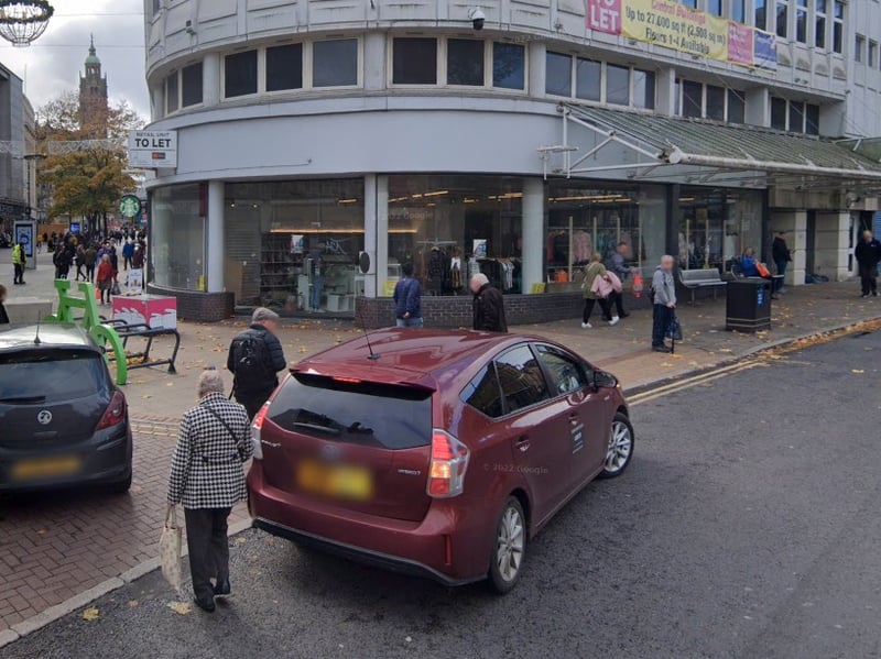 This picture from November 2022 shows the Coles Corner unit was used as a charity shop. In the background, the former H Samuel jewellery shop is to let.