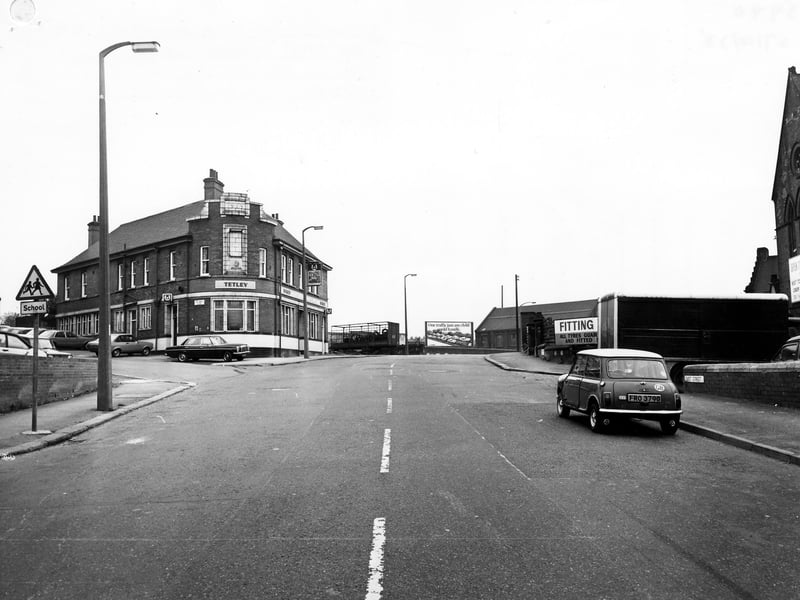 East Street looking east, showing the junction with Ellerby Lane on the left. The Fisherman's Hut public house is on the corner. On the right of the picture is Spen Tyres. As the road turns to the right it becomes Cross Green Lane. Pictured in October 1978.