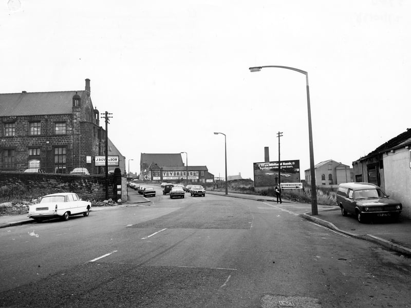 Looking east along East Street, showing the junction with Low Fold on the right. Beyond this is an advertising hoarding for Midland Bank. J. Boyd & Son Clothiers is on the left of the picture and Spen Tyres is in the background. Pictured in October 1978.