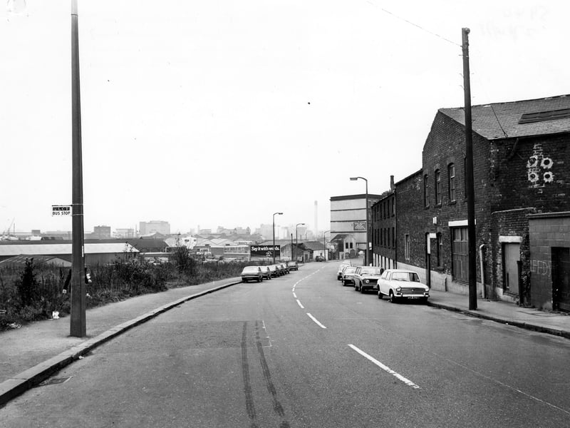 Looking along East Street with factories on both sides of the road. Several cars are parked on the road. Pictured in October 1978.