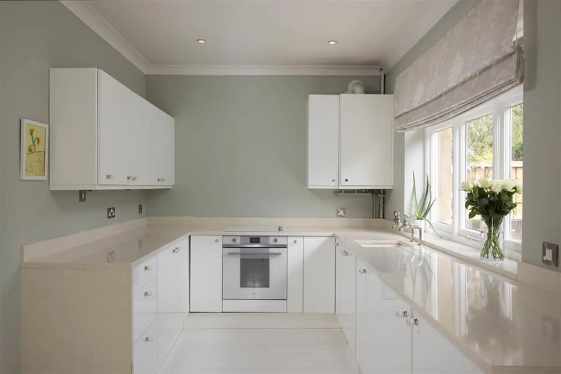 The high-spec fitted kitchen includes quartz worktops, a Smeg oven, and fitted appliances with plenty of space