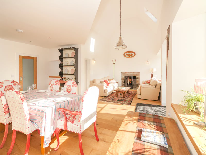 The open-plan sitting and dining space is well lit