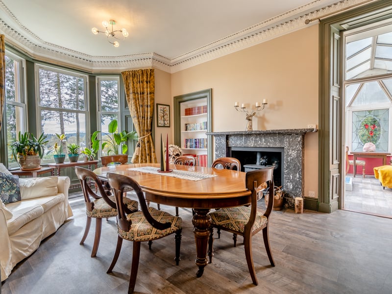 The dining room features a stove ad leads to a conservatory