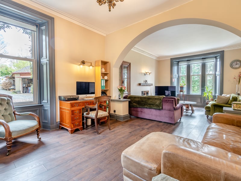 The sitting room of the property features an archway