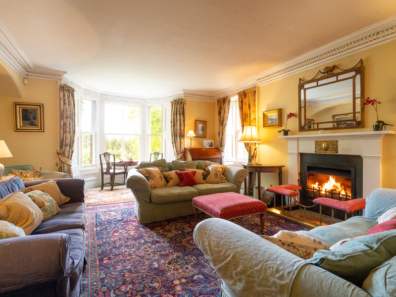 The living room feature a large fireplace and bay window