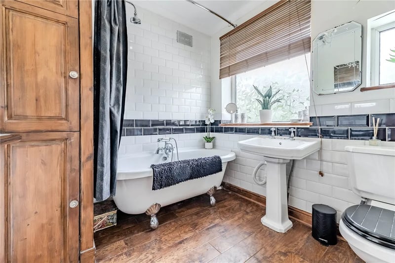 The bathroom has a three piece suite with a claw footed bath, a cast iron roll top radiator incorporating a heated towel rail, built in storage and laminate flooring.