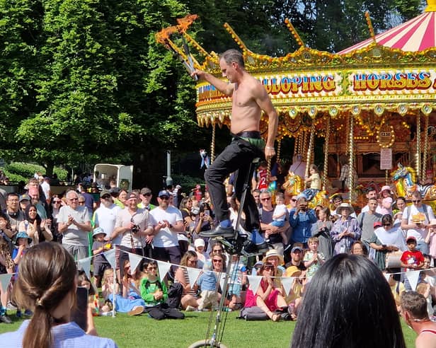 An entertainer juggled with fire sticks while on a unicycle at the Sheffield May Fayre at Weston Park, Sheffield. Photo: David Kessen, National World