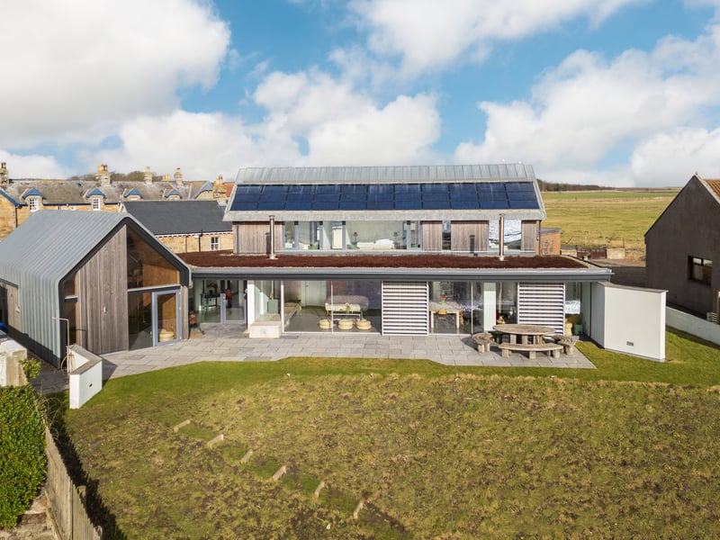 As the building is approached, visitors are hit by the contemporary building clad in larch, zinc flashing and a white render sitting under a zinc roof.