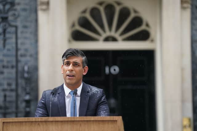 Rishi Sunak stood at a lectern in the pouring rain to call the general election for July 4.  Picture: Stefan Rousseau/PA Wire