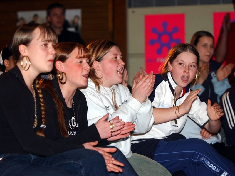 Pupils show their appreciation for boy band D-SIDE who performed at the school in April 2003