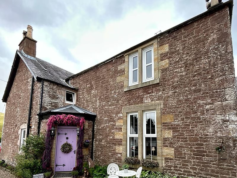 The exterior of Old Manse has been updated with a colourful lilac door