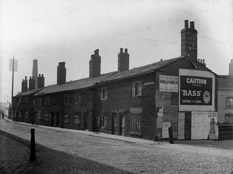 Taken in July 1903, old cottages on Water Lane scheduled for demolition. On the gable end wall is an advertisement for Bass beer.