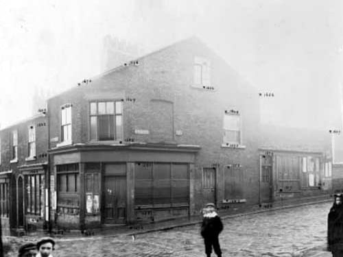 Meanwood Street and Camp Road Improvement, showing boarded up shops. Children in the foreground. Pictured in October 1903.