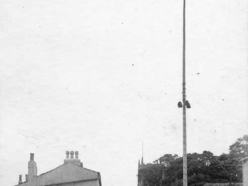 This early 20th century view of the Maypole was taken from close to the junction with Main Street and The Cross in August 1903. The Black Swan pub adjoins the cottages on the left at numbers 7 and 9. The Cross is visible at the rear of the Maypole and All Saints Church is in the background, right of centre. The old Cross can now be found in the churchyard.