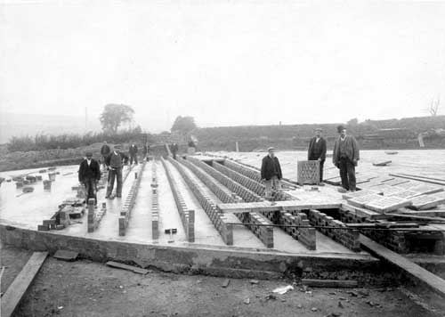 View of filter at Rodley Sewerage Farm showing construction and construction workers. Pictured in August 1903.