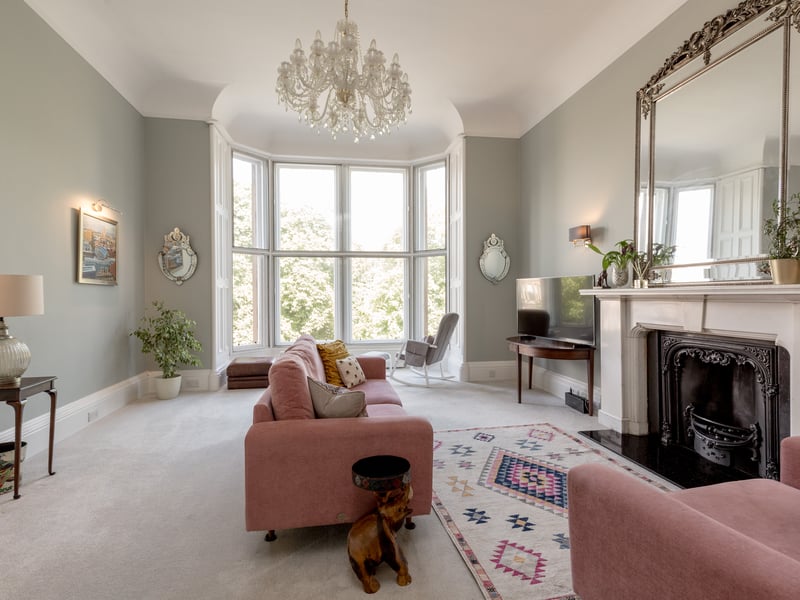 The living room features a magnificent fire surround and large bay window.