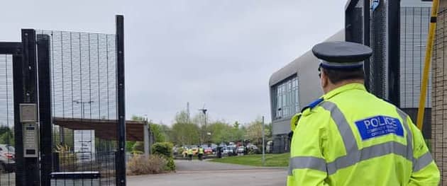 Picture shows a police officer guarding the school's main gate this morning at Birley Academy, on Birley Lane on May 1, following an incident which left three injured 
