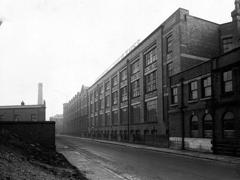 Looking north-east along Springwell Street from the junction with Holbeck Lane in February 1945. Maenson House Clothing Works, owned by Joseph May and Sons Leeds Ltd., occupies most of the length of the right-hand side. The premises are also occupied by Tom Dixon, corn dealer.