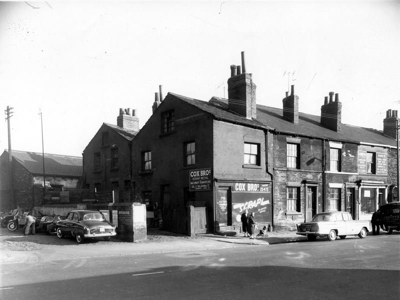 On the left Viaduct Place has a parked car and motor cycles, part of the business of Harold Barrett Ltd, which is on the left, out of view. Moving right is number 242 Cox Brothers scrap metal dealers, they also dismantled machinery and had premises on Talaverd Street. Next 240, 238 are houses. Leatherland dealing in luggage, handbags and repairs was on the right at 236. Pictured in October 1959.