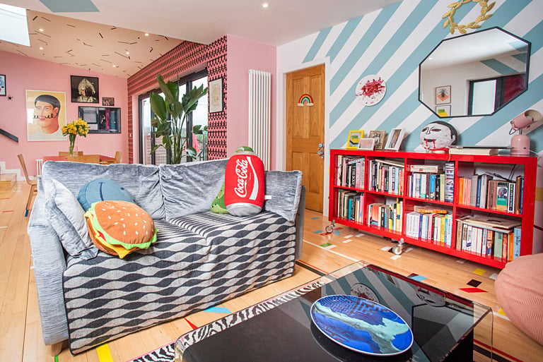 The twice-extended home boasts clever decorating techniques and reclaimed materials including school gym hall flooring complete with colourful markers.