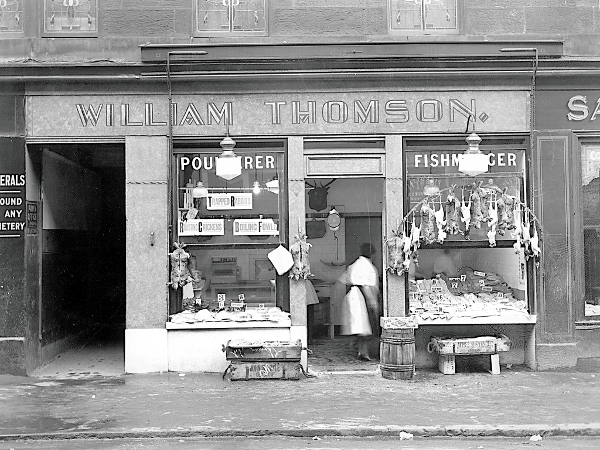 A fishmonger keeps busy at their shop at 130 Bardowie Street in March, 1933.