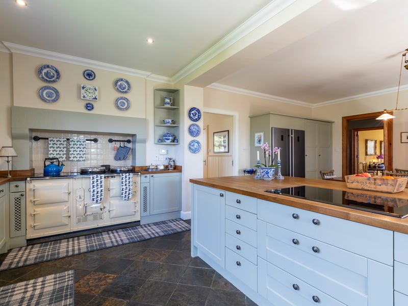 The traditional style kitchen has an Aga range oven.