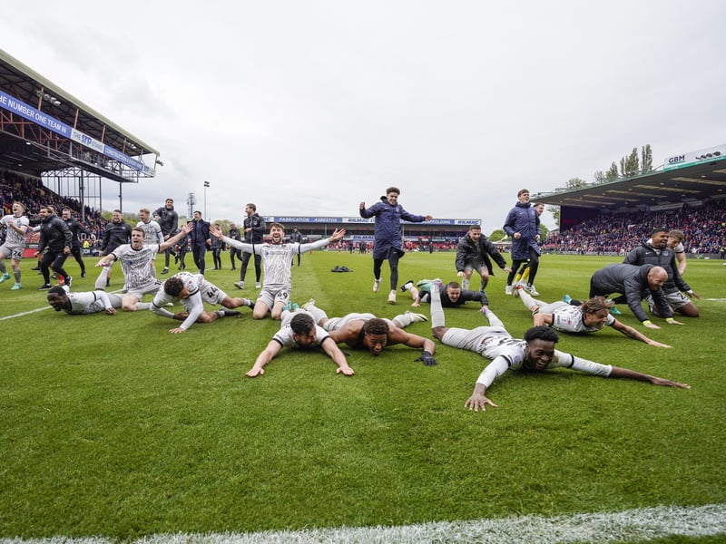 Pompey players celebrate with a Klinsmann at Lincoln on the final day.